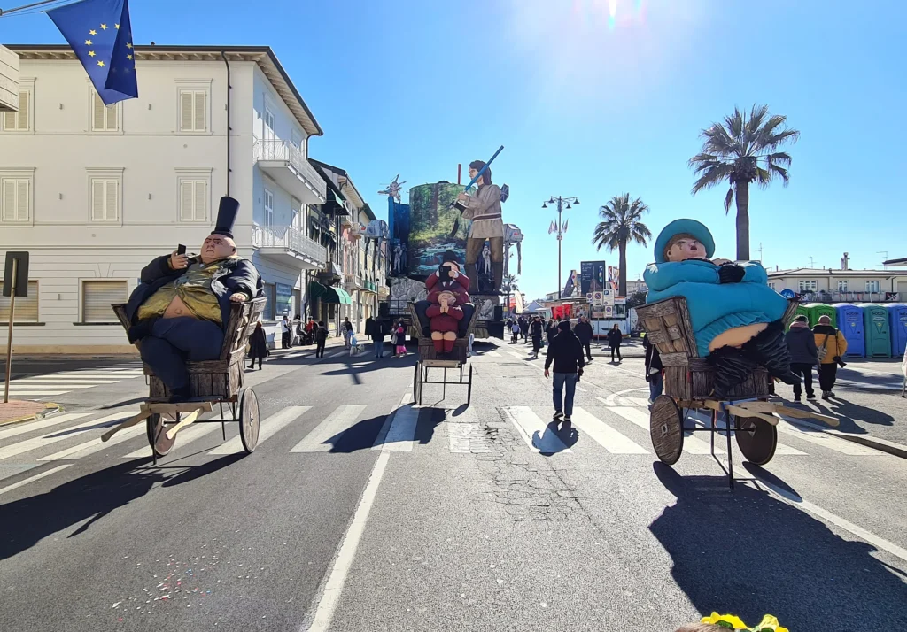 Des masques en papier mâché sur de petits chariots le long de l'avenue, à Viareggio, par une journée ensoleillée